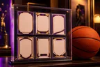 Basketball trading cards in a display case beside an orange ball